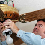 electrician removing ceiling fan