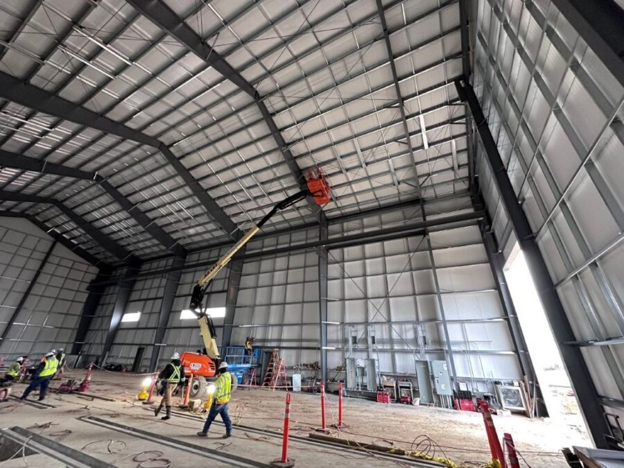 Electricians working inside a large industrial facility