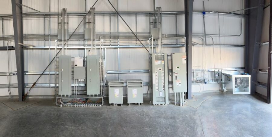Several electrial panels against wall of warehouse
